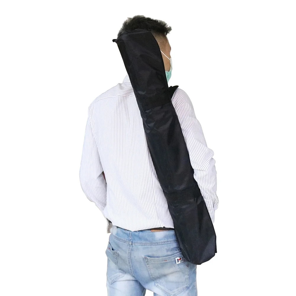 Backdrop stand packed in its carry bag over the shoulder