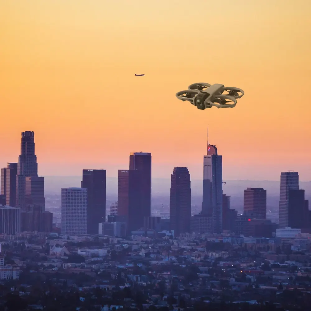 DJI Avata 360 against a city skyline at dusk (composite image)