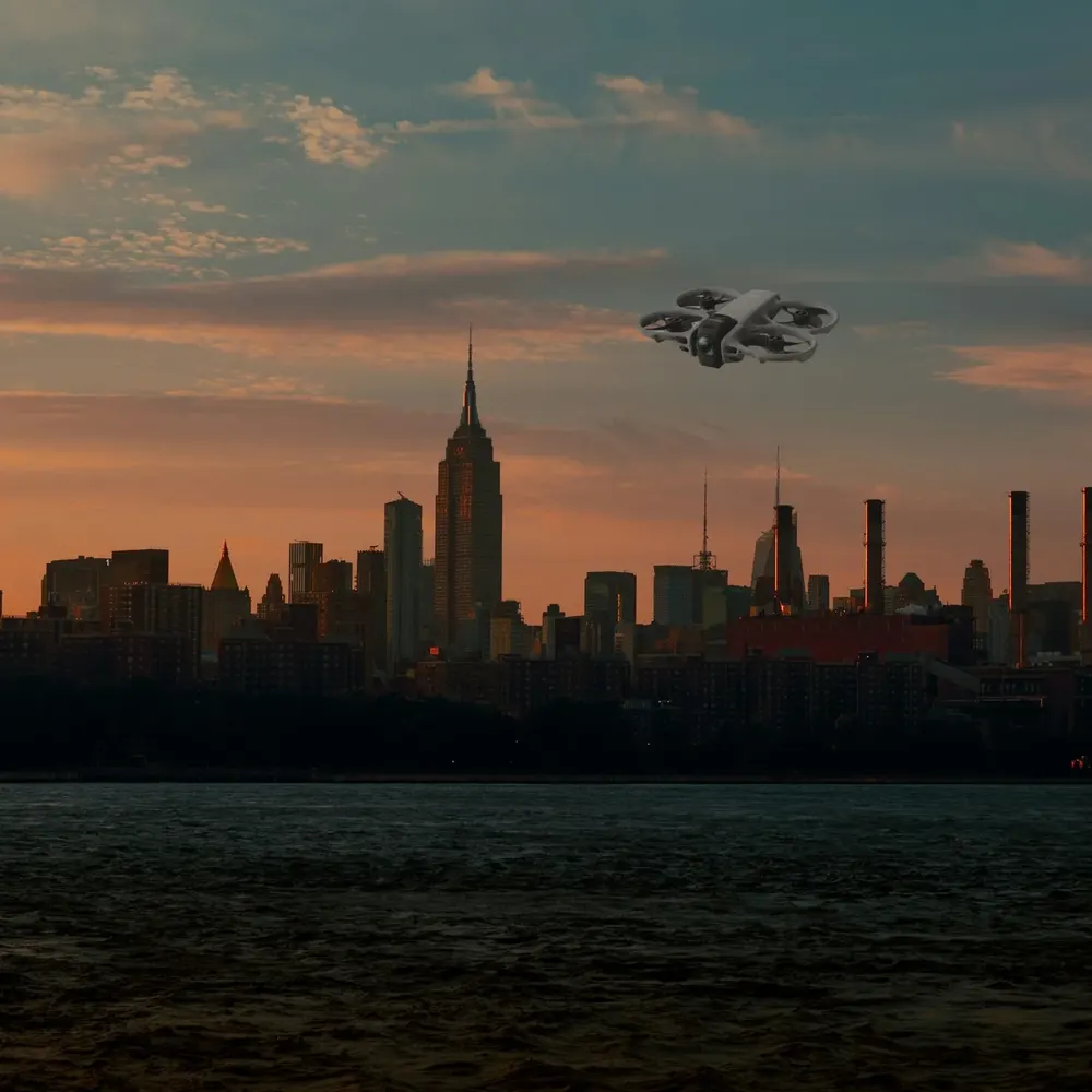 DJI Avata 360 against the New York skyline at sunset (composite image)