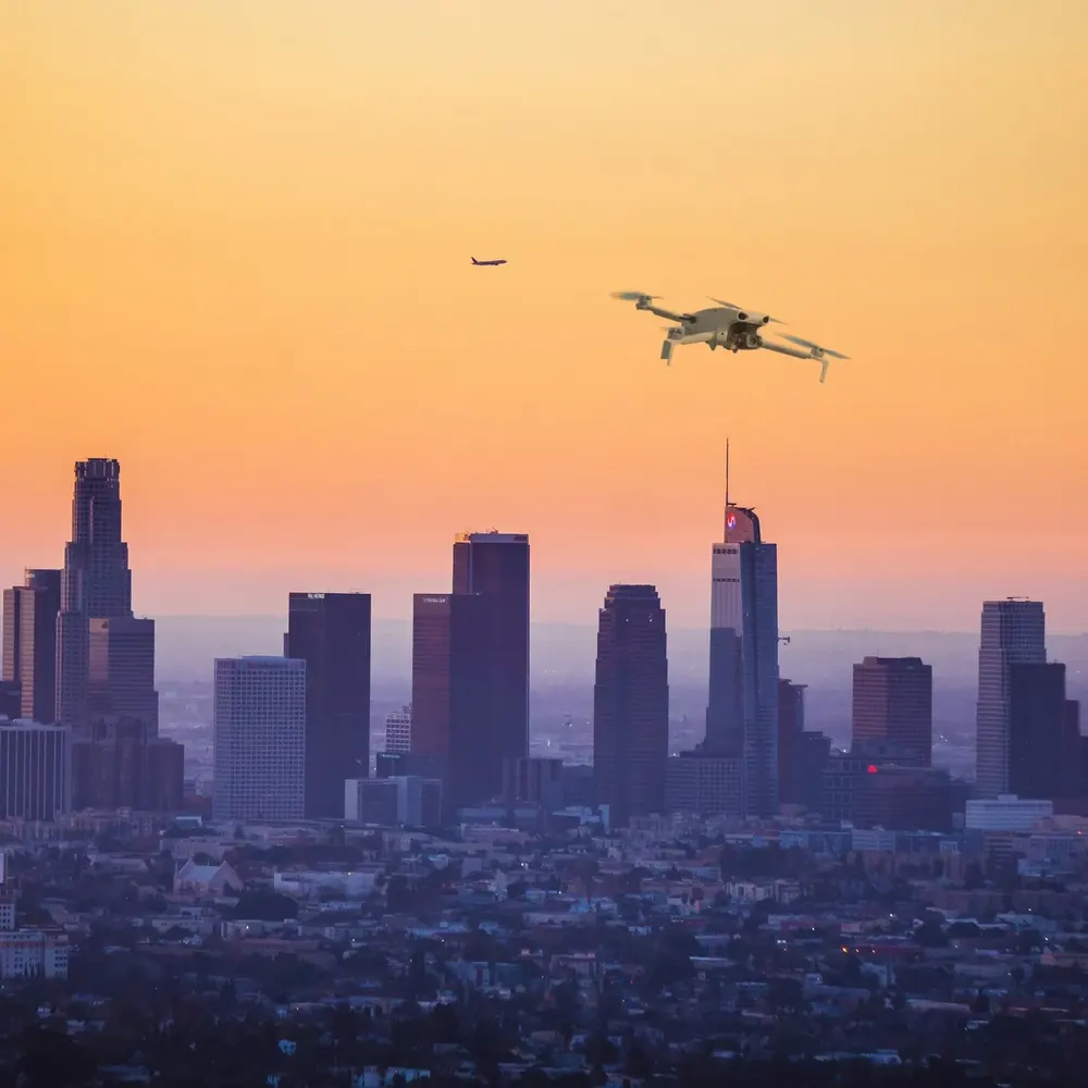DJI Lito X1 against a city skyline at dusk (composite image)