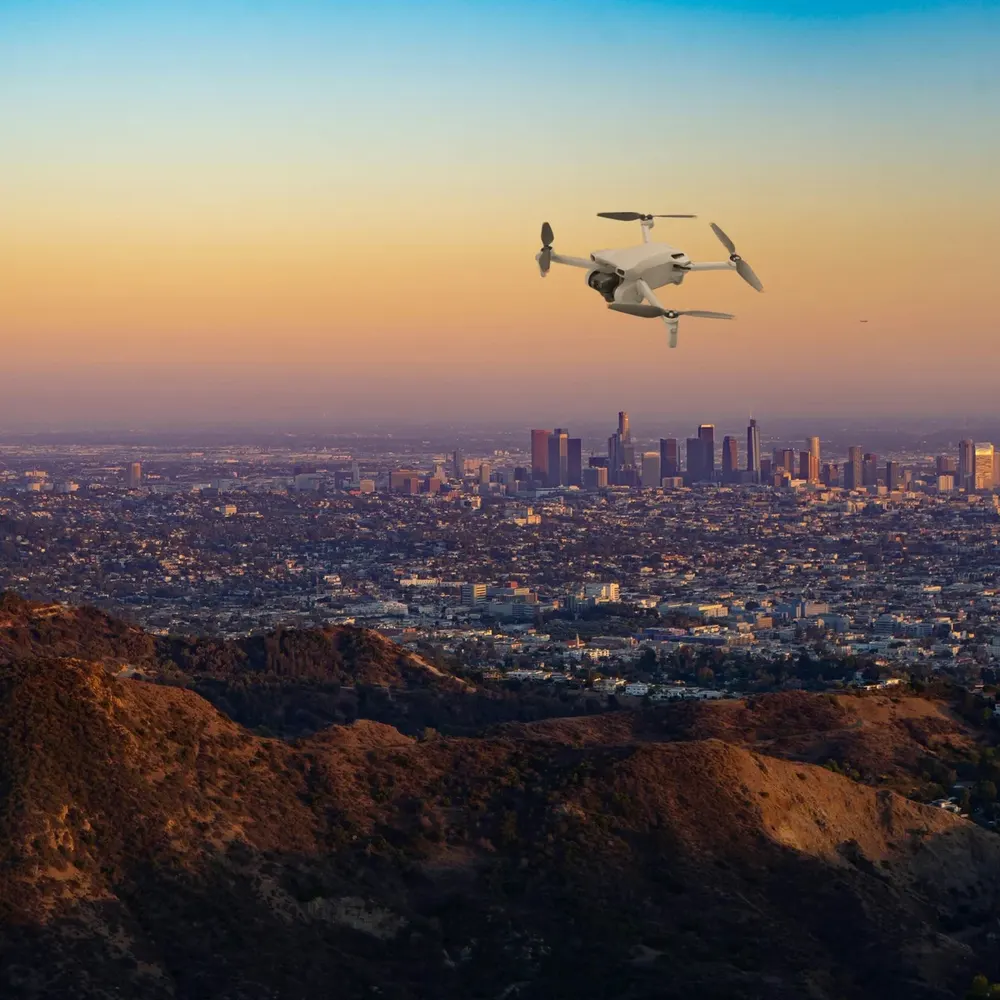 DJI Mini 3 against hills and open sky (composite image)