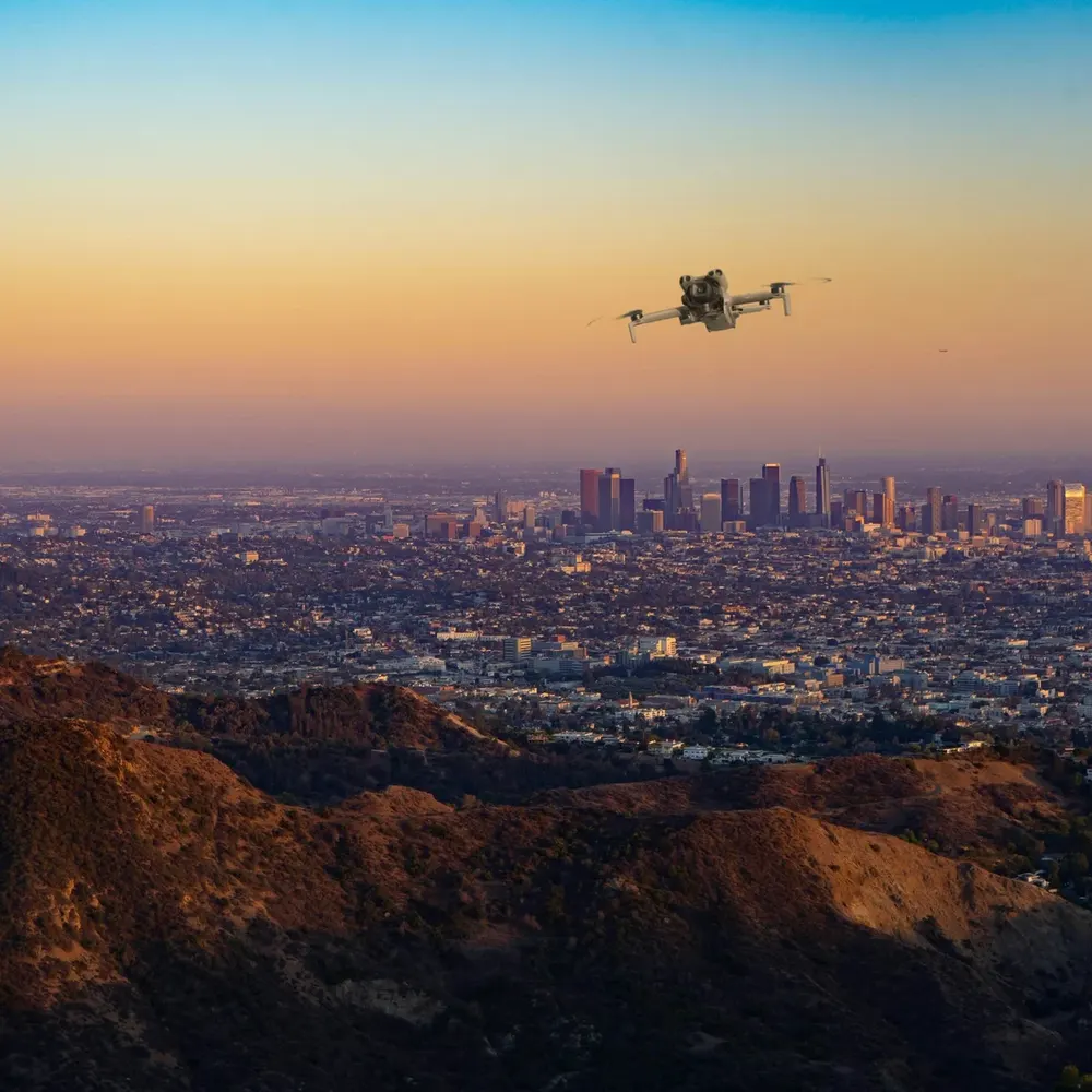 DJI Mini 5 Pro against hills and open sky (composite image)
