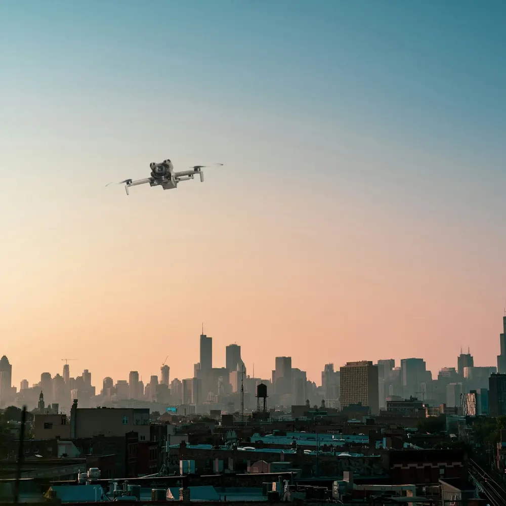 DJI Mini 5 Pro against a city skyline (composite image)